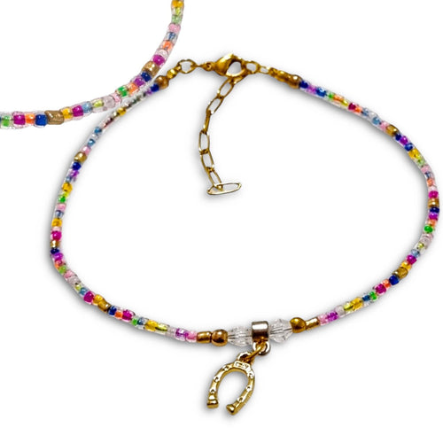 Colorful beaded horseshoe bracelet with gold metal findings and crystal accents.