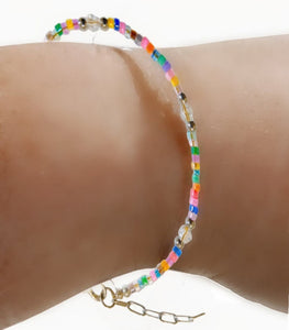 Colorful small seedbead bracelet with silver stainless steel beads and lobster claw clasp.