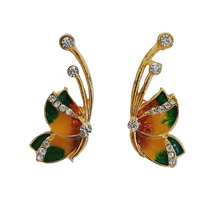 Butterfly gold earrings with colorful wings and sparkling clear stones.