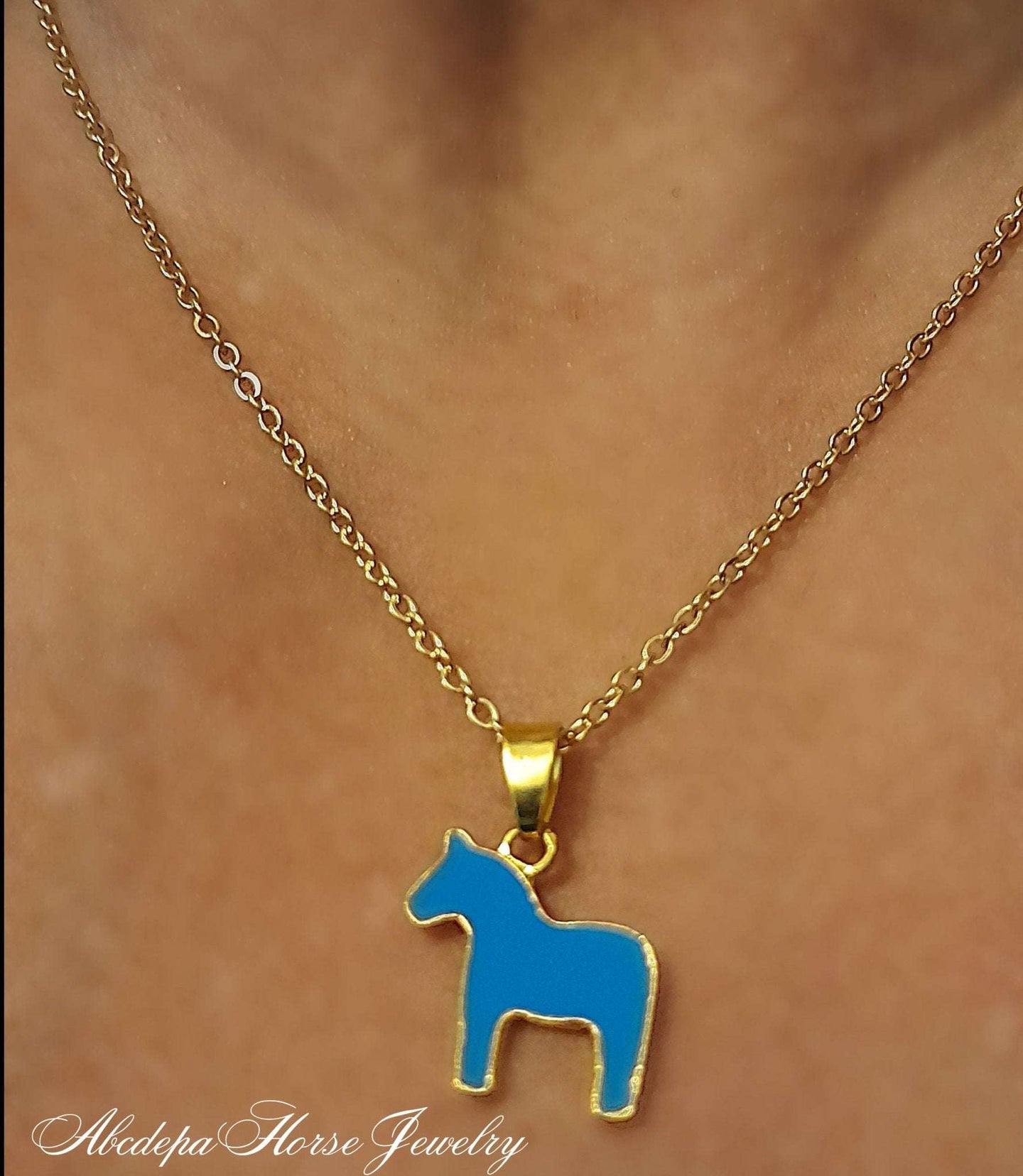 Blue and Gold Pony Pendant Necklace with stainless steel chain on neck