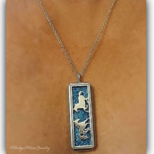 Blue Silver Horse Locket Necklace with long chain and cantering horse design.