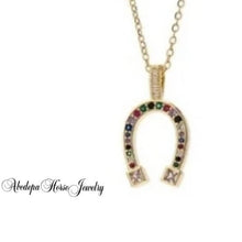 Colourful horseshoe gold pendant necklace with stones on a gold-plated chain.