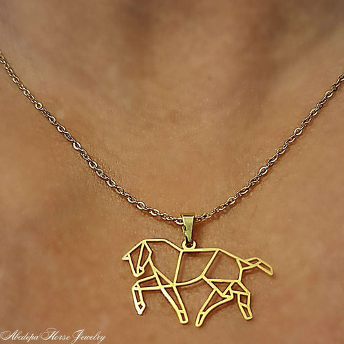 Geometric horse pendant necklace on gold chain.