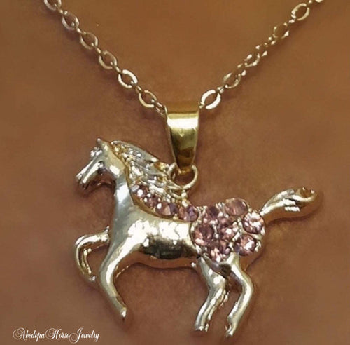 Gold pony necklace with pink crystal accents on 18kgp chain.