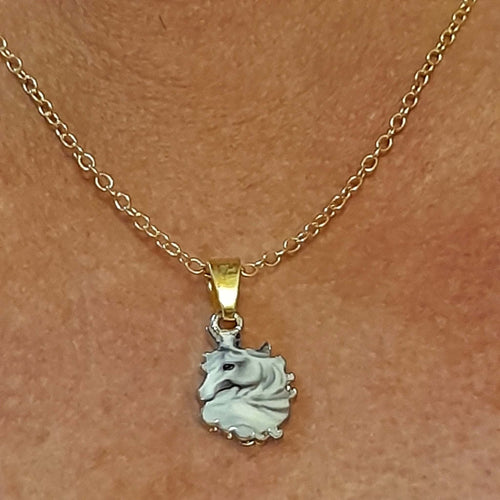 Gold-plated necklace with grey horsehead pendant on stainless steel chain.