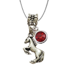 Horse Rearing with Charm Cluster Necklace featuring silver patterned charm and red birthstone.