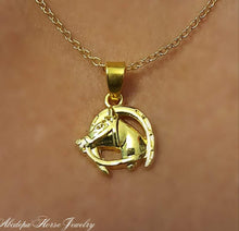 Gold horsehead in horseshoe pendant necklace.