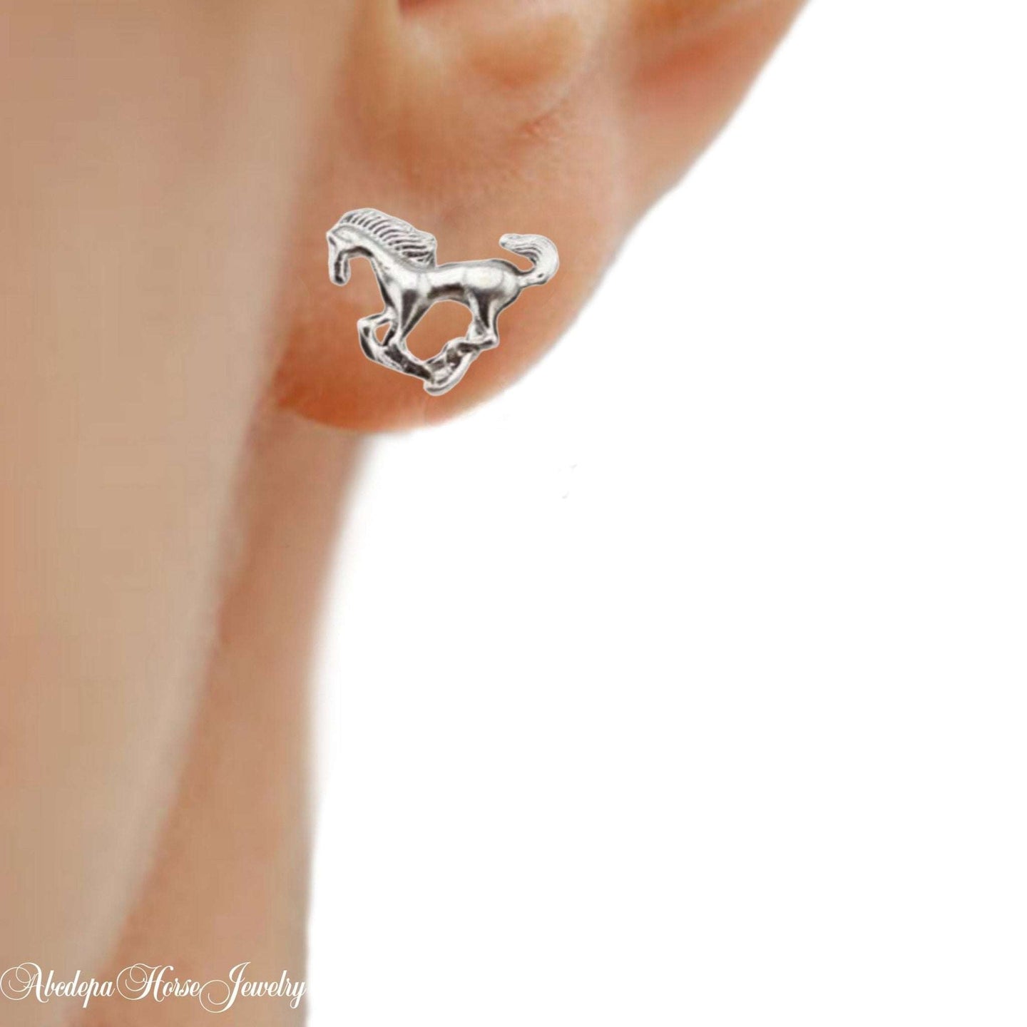 Silver-toned horse galloping stud earrings with rubber backs.