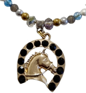 Horseshoe gemstone beaded necklace with gold horse head and black crystal stones.