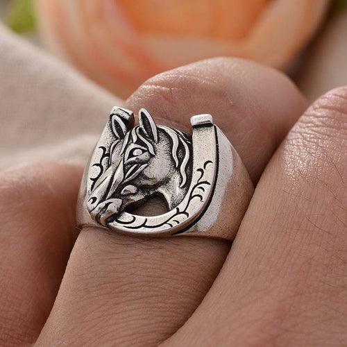 Silver horseshoe horsehead ring on finger, versatile size design.