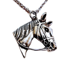 Large horsehead pendant necklace in silver with bridle details on stainless steel chain.