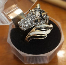 Tail Horse Ring with crystal stones and black and white design in a jewelry box.