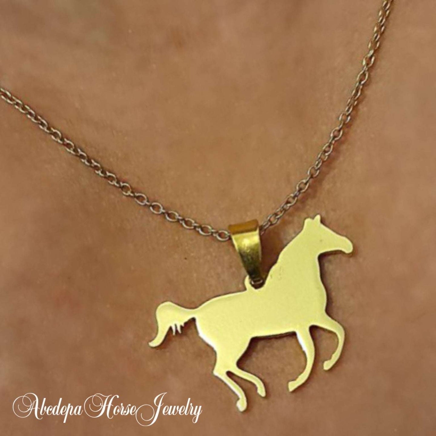 Gold Horse Cantering Necklace on stainless steel chain with customizable letter charm.