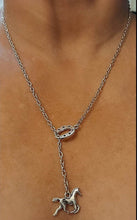 Silver pull-thru horse necklace with horseshoe and horse pendant design.