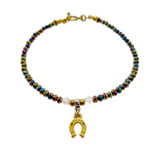 Rainbow Crystal Rondels Gold Horseshoe Bracelet with antique gold metal toggle clasp.