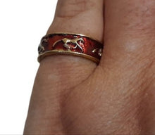 Red Gold Horse Ring - on finger, featuring gold horses on a red-coated band.