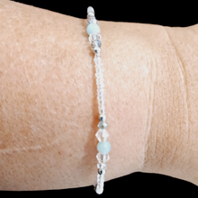 Amonizite anklet featuring green and blue gemstones, purple jade, crystal beads, and stainless steel accents.