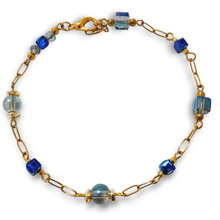 Blue cube round crystal gold chain bracelet with beaded charm design.