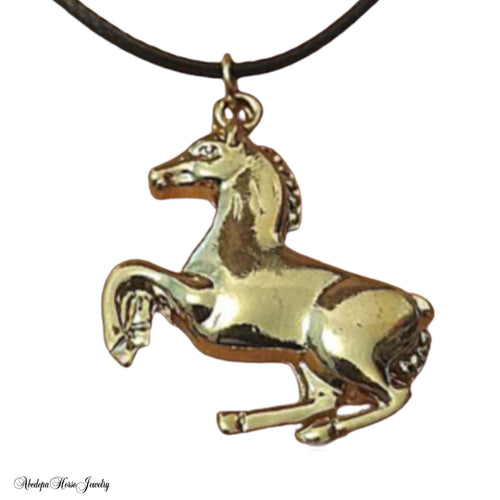 Black cord choker necklace with gold plated rearing horse pendant.