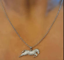 Silver and clear zirconia horse pendant necklace on a model, featuring a crystal-inlaid pony on a stainless steel chain.