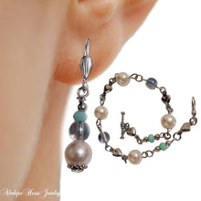 Elegant silver bead dangle earrings set with matching bracelet.