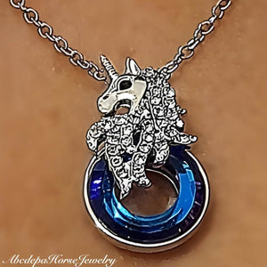 Unicorn silver pendant necklace with blue-purple crystal charm.