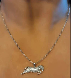 Silver and Clear Zirconia Horse Pendant Necklace on a model, featuring crystal zircon stones and a stainless steel chain.